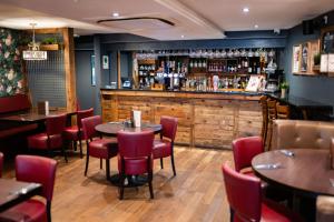 a restaurant with tables and chairs and a bar at Foundry 34 in Penrith