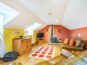 a living room with a couch and a tv at Smugglers View Nr Whitby in Ravenscar