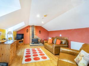 a living room with a couch and a television at Smugglers View Nr Whitby in Ravenscar