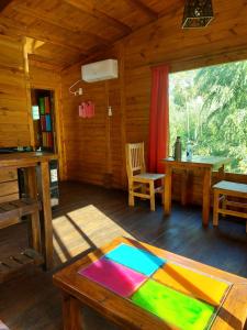a living room of a log cabin with a table at Cabañas Amo Río - Delta in Tigre
