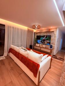 a bedroom with a large bed and a fireplace at House Paraíso Flecheiras in Trairi +46 photos