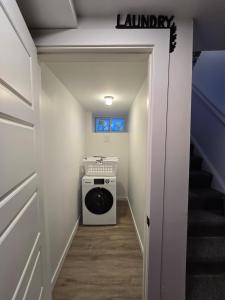 a laundry room with a washer and dryer at Downtown Detroit Hidden Gem Walk to Venues & DMC in Detroit