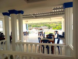 a dining room with a table and chairs on a porch at Hotel Colombia - Apulo in Apulo