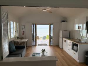 a kitchen and living room with a view of the ocean at Ellis Beach Oceanfront Holiday Park in Palm Cove
