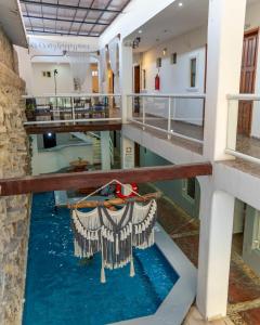 a pool of water in a building with a boat in it at Ahava Hotel in Playa del Carmen +11 photos