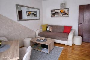 a living room with a couch and a table at MakiLen in Vrnjačka Banja