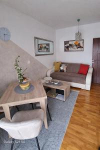 a living room with a couch and a table at MakiLen in Vrnjačka Banja