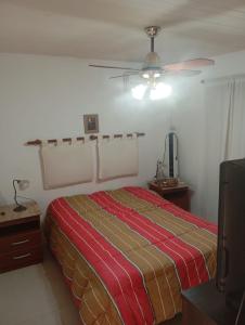 a bedroom with a bed and a ceiling fan at Espacio Armonia Junin Balneario in Junín +17 photos