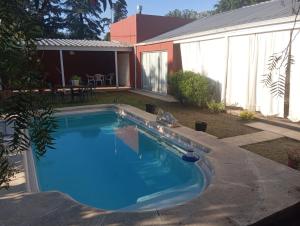 a swimming pool in the backyard of a house at Espacio Armonia Junin Balneario in Junín