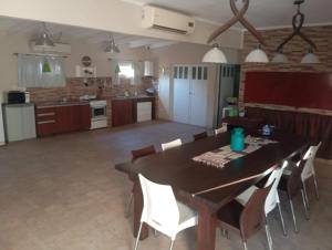a kitchen with a dining room table and chairs at Espacio Armonia Junin Balneario in Junín