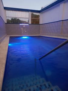 a large pool of blue water in a building at Hotel Colombia - Apulo in Apulo