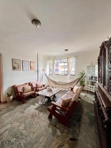 a living room with a hammock in the middle at Quarto Privativo na AvBeira mar - Apto familiar in Fortaleza
