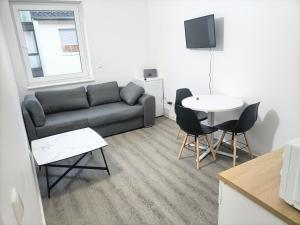 a living room with a couch and a table at Waldstreet in Rüsselsheim