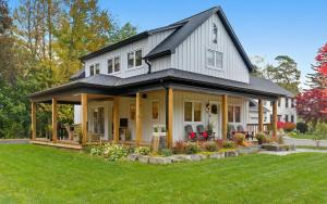 a large white house with a gambrel roof at Spruce Suite Historic NOTL - VINEYARD RETREAT in Niagara-on-the-Lake