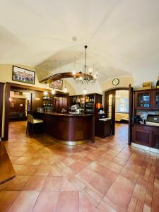 a large lobby with a bar and a restaurant at Hotel Zámek Berchtold in Kunice