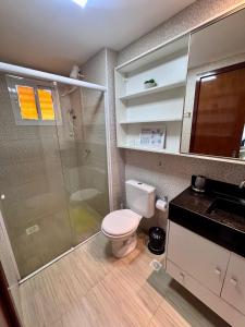 a bathroom with a shower and a toilet and a sink at Elegance Residences Cumbuco in Cumbuco +8 photos