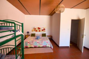 a bedroom with a bed and a bunk bed at Palacete Dos Alcaides in Minas de São Domingos +100 photos