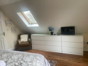 a bedroom with a bed and a tv on a dresser at Tourmakeady Self Catering in Toormakeady +4 photos