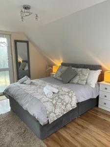 a bedroom with a bed with towels on it at Tourmakeady Self Catering in Toormakeady