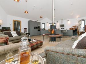 a living room with two couches and a fireplace at Millbank in Ballindalloch
