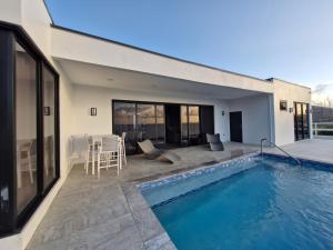 a house with a swimming pool and a patio at Samaya Villa in Mesopotamia