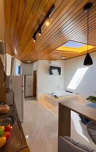 a kitchen with a ceiling with a skylight at Suíte dos Sonhos-Climatizada,Hidromassagem,Garagem in Piratuba