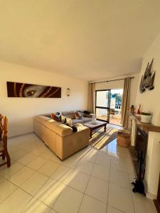 a living room with a couch and a table at Casa Julio-Rooftop Terrace & Pool 5 Min to Beach in Carvoeiro