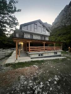 a house that is sitting on top of a field at Guest House Ropojan in Vusanje