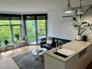 a kitchen and living room with a couch and a table at Centrepoint Units Heidelberg in Melbourne