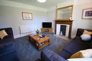 a living room with a couch and a coffee table at New! Luxury 4 Bedroom Detached House - Central Baslow in Baslow