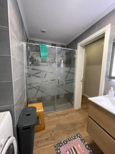 a bathroom with a shower with a glass shower stall at Azorean Sunset Loft 1 in Ribeira Grande +12 photos