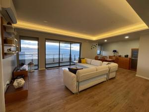 a living room with a white couch and a table at Azorean Sunset Loft 1 in Ribeira Grande