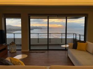 a living room with a view of the ocean at Azorean Sunset Loft 1 in Ribeira Grande
