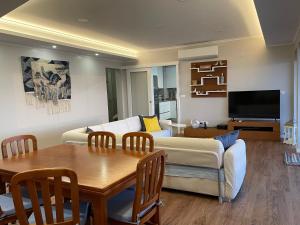 a living room with a couch and a table at Azorean Sunset Loft 1 in Ribeira Grande