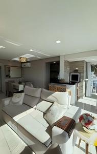 a living room with a couch and a table at Apto Margaridas|3Q,todo Climatizado,ao lado Termas in Piratuba