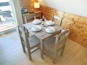 a wooden table with chairs and plates on it at Glenlivet View in Auchnastank