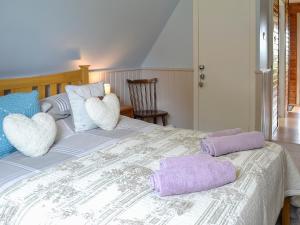 a bedroom with a bed with two pillows on it at Glenlivet View in Auchnastank