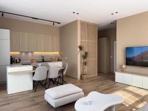 a kitchen and living room with a table and chairs at Elite Sunset Residence in Vlorë