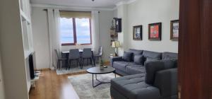 a living room with a couch and a table at Aldo's apartments in Pogradec