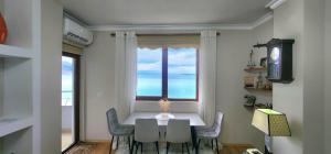 a dining room with a table and a window at Aldo's apartments in Pogradec