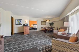 a living room with a couch and a table at Crossroads Hotel and Huron Event Center in Huron