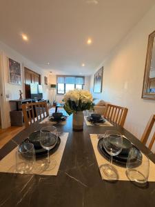 a dining room table with wine glasses on it at VIP apartment paddington in London
