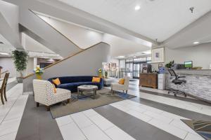 a lobby with a blue couch and chairs at Crossroads Hotel and Huron Event Center in Huron