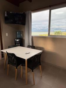 a table and chairs in a room with a window at Don Isidro in Miramar