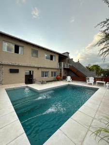 a swimming pool in front of a house at Don Isidro in Miramar