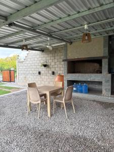 a wooden table and two chairs sitting under a patio at Don Isidro in Miramar