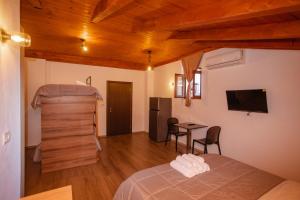 a bedroom with a bed and a table in a room at Bellway Guest House in Shkodër
