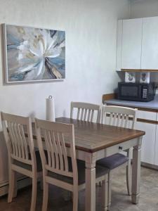 a kitchen with a wooden table and chairs at RJN in Fairbanks