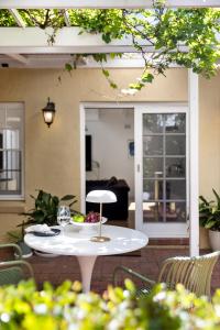 a white table and chairs on a patio at Eastside Oasis - Heart of Norwood with Poolside Garden in Norwood