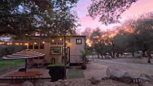 a house with a picnic table in front of it at The Sundance Tiny Home in Pauma Valley